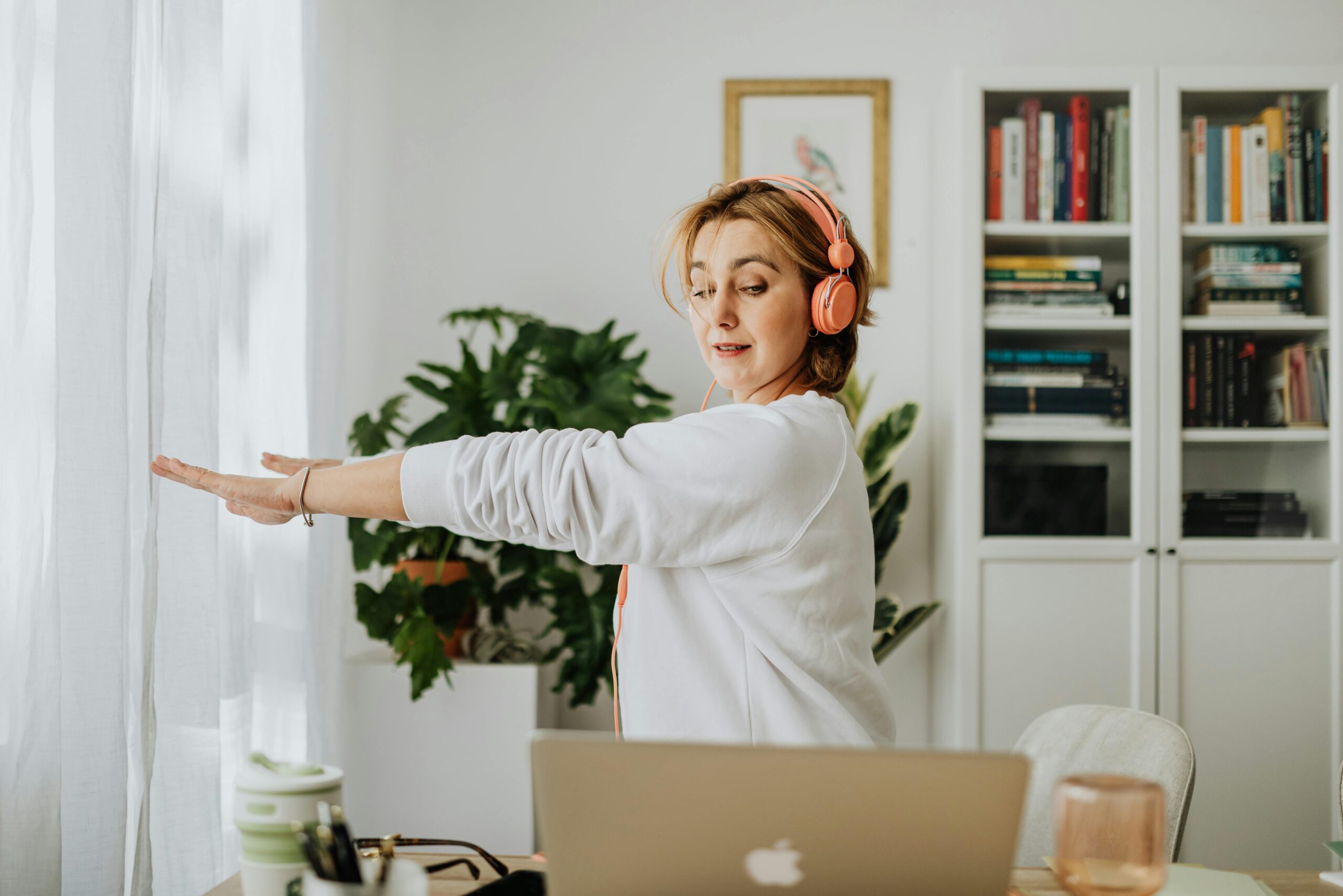 Office worker using a standing desk to alternate between sitting and standing during work hours