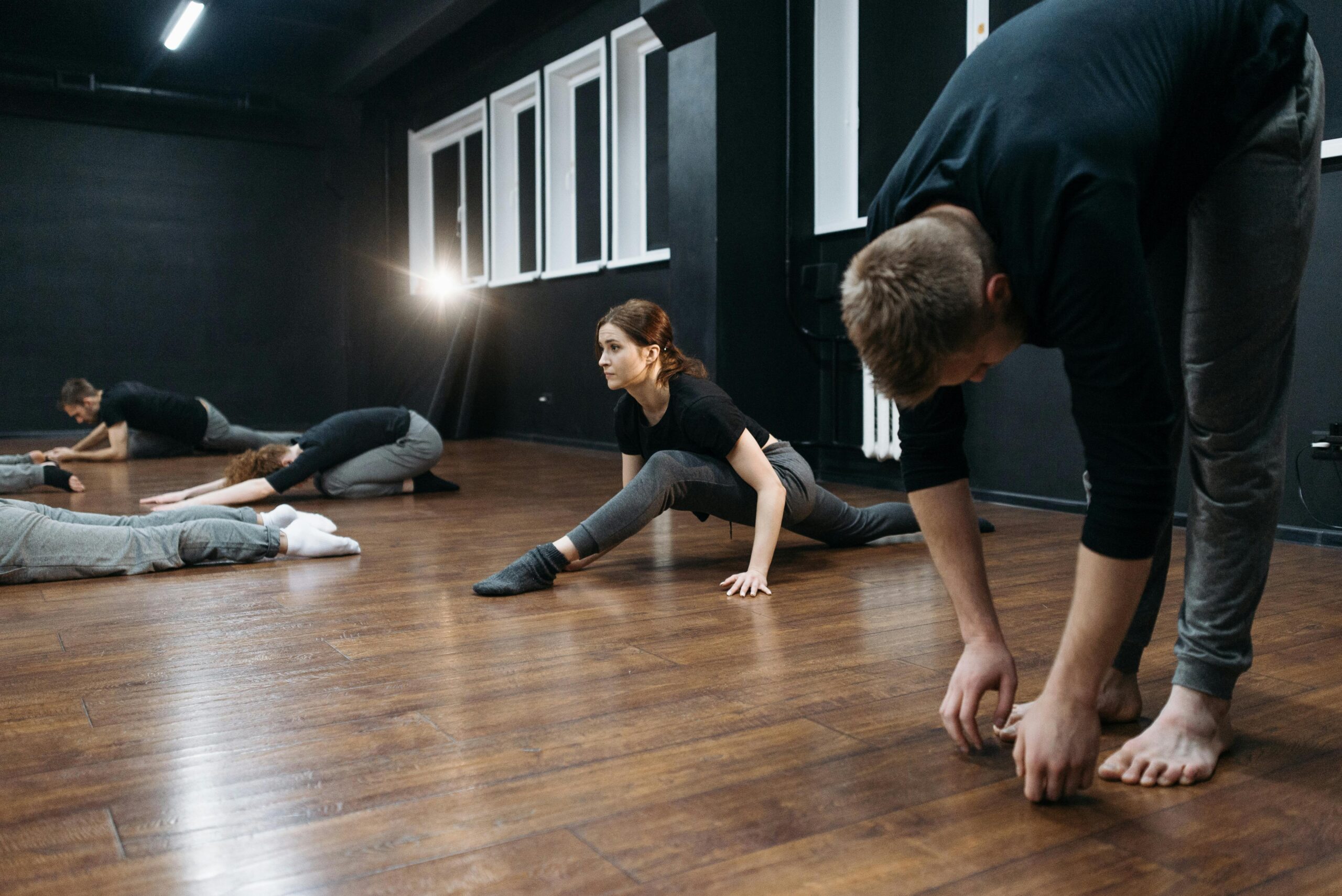 Person doing a gentle hamstring stretch on a yoga mat at home, representing simple daily moves to boost flexibility
